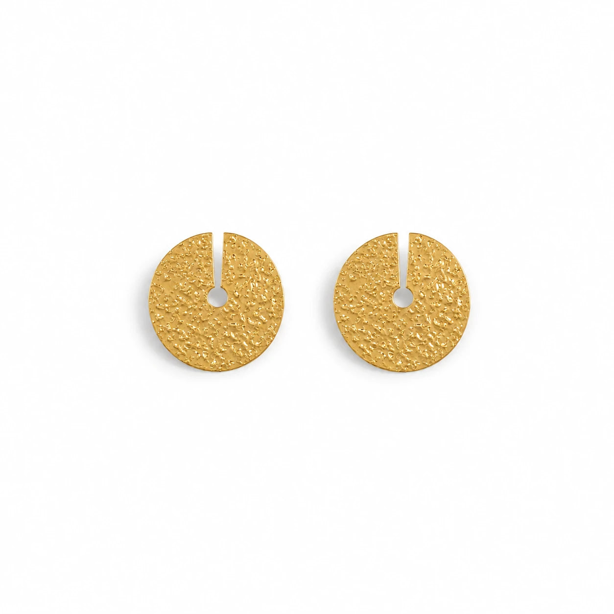 A pair of textured gold disc earrings with a small central cutout, displayed on a clean white background.