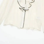 Close-up detail of Belle Blouse long sleeve, hardware detail