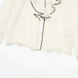 Close-up detail of Belle Blouse long sleeve, hardware detail