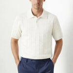 BIELLA Cable Knit Polo shown in a lifestyle setting, seated view