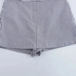 Coastal shorts shown in a lifestyle setting, full length view