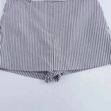 Coastal shorts shown in a lifestyle setting, full length view