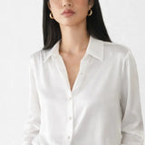 Elegant Satin Blouse shown in a lifestyle setting, seated view