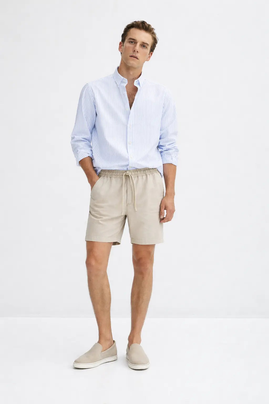 Fez Linen Shorts shown in a lifestyle setting, full length view