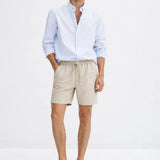 Fez Linen Shorts shown in a lifestyle setting, full length view