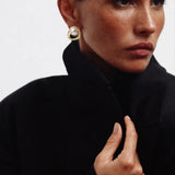 Golden Pearl Earrings shown in a lifestyle setting