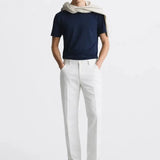 Lino Pants shown in a lifestyle setting, cropped view