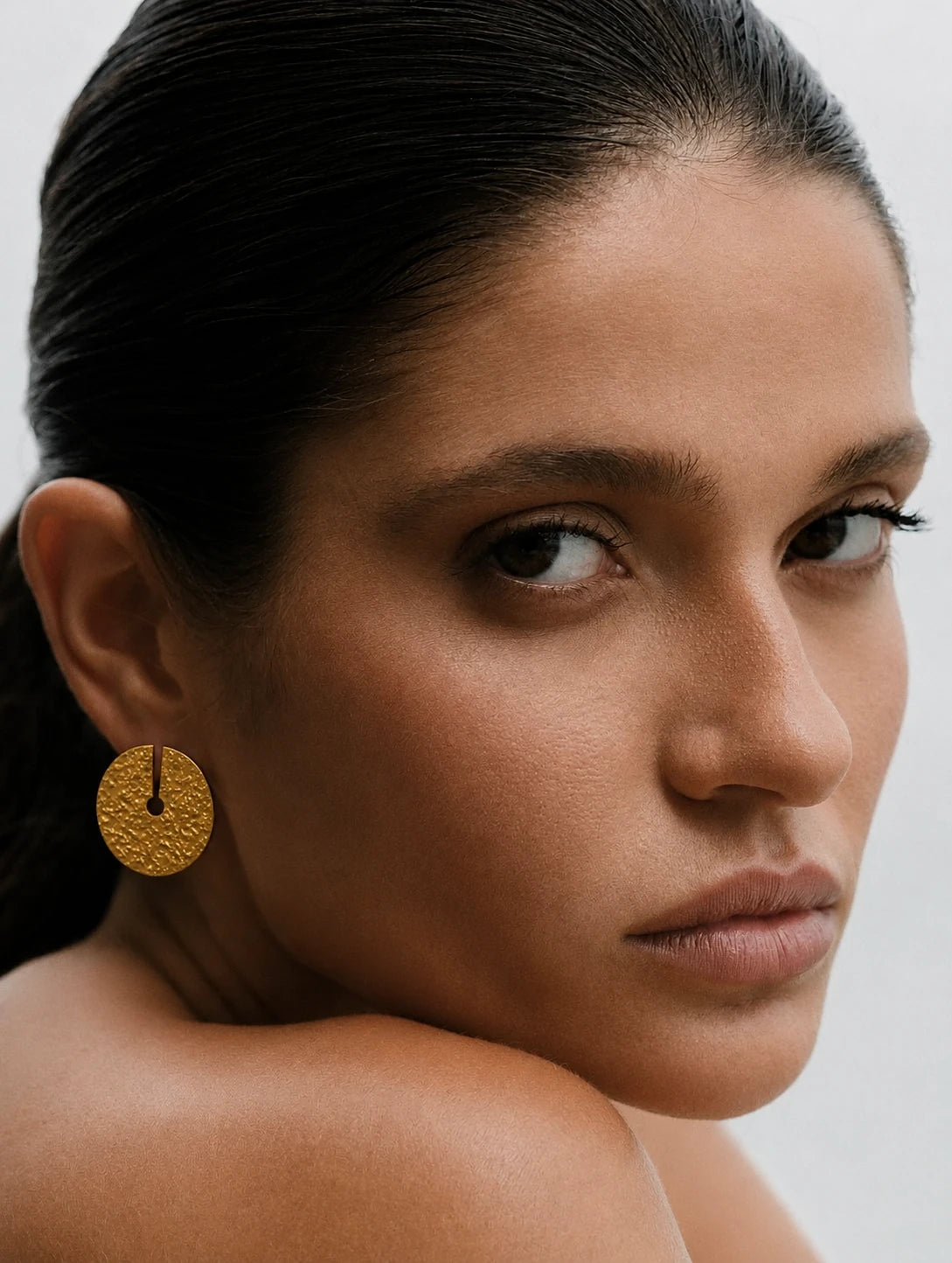 Solina Earrings shown in a lifestyle setting, alternate view