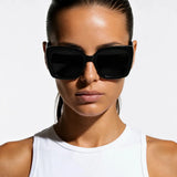 UltraLux Vision Sunglases shown in a lifestyle setting, full length view